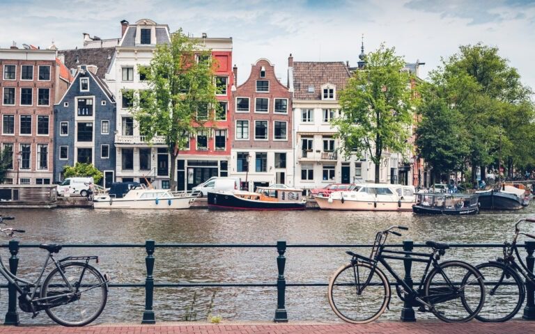Bikes parked along a canal bridge in Amsterdam’s city center