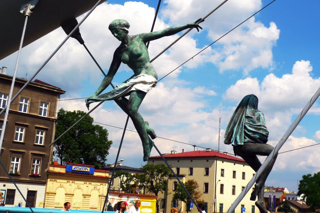 Most Instagrammable spots in Kraków - acrobats statues on the Bernatek Footbridge