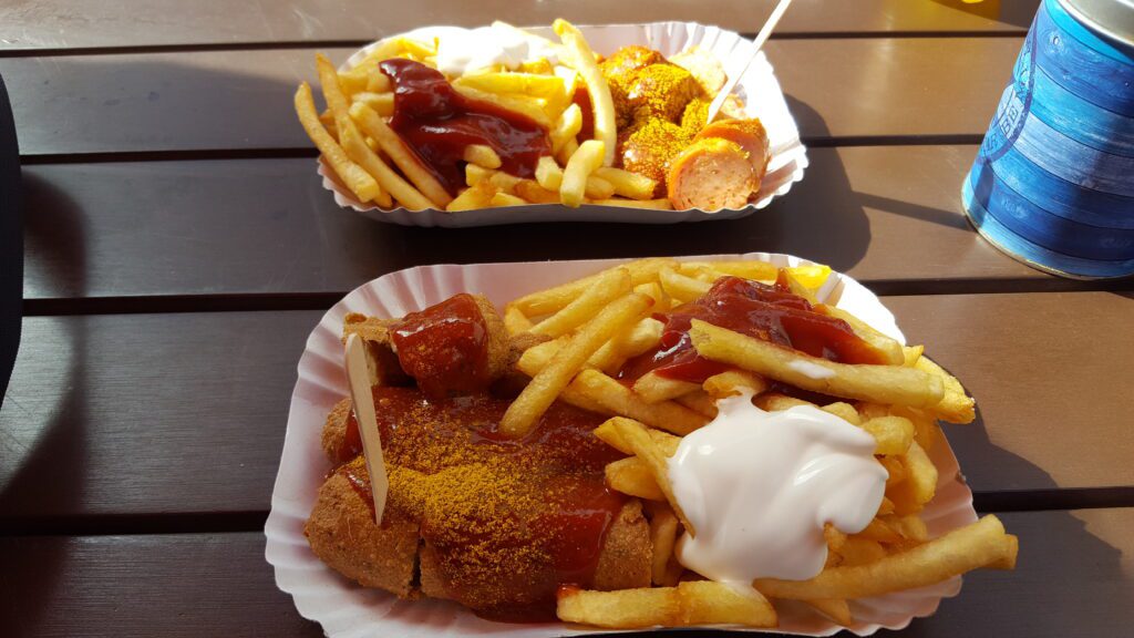 Currywurst in Berlin: A taste of the city - two portions of vegan currywursts and fries on a table