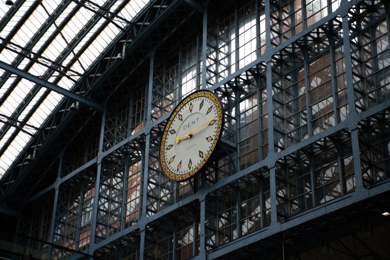 Golden clock hanging on a station wall