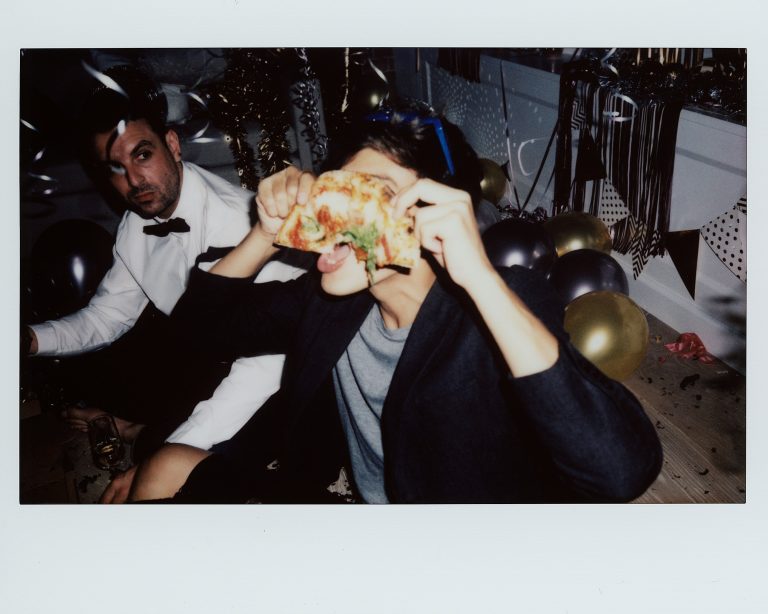 Partygoer eating late night pizza after drinks