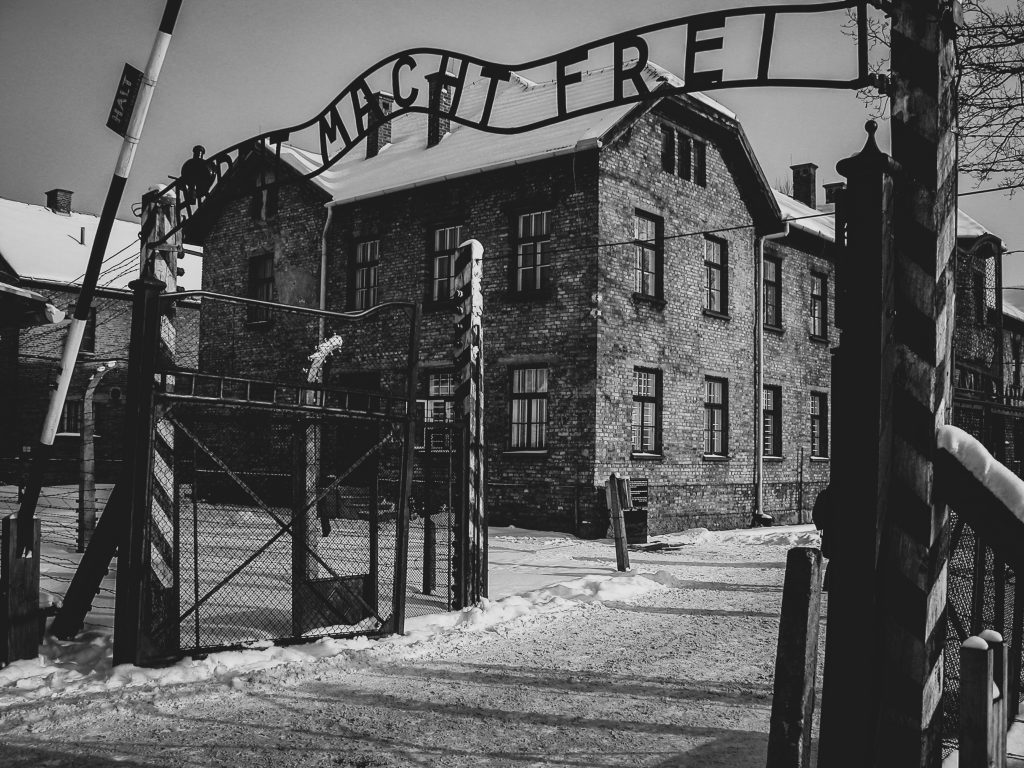 Day trip to Auschwitz: Auschwitz gate with “Arbeit macht frei” in winter snow