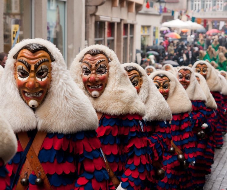 People in colorful masks and costumes parading at Düsseldorf Carnival