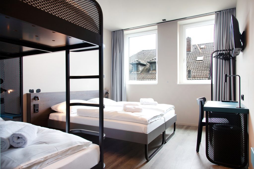 MEININGER Hotel Bremen Hauptbahnhof room with a double bed and a bunk bed for friends or family