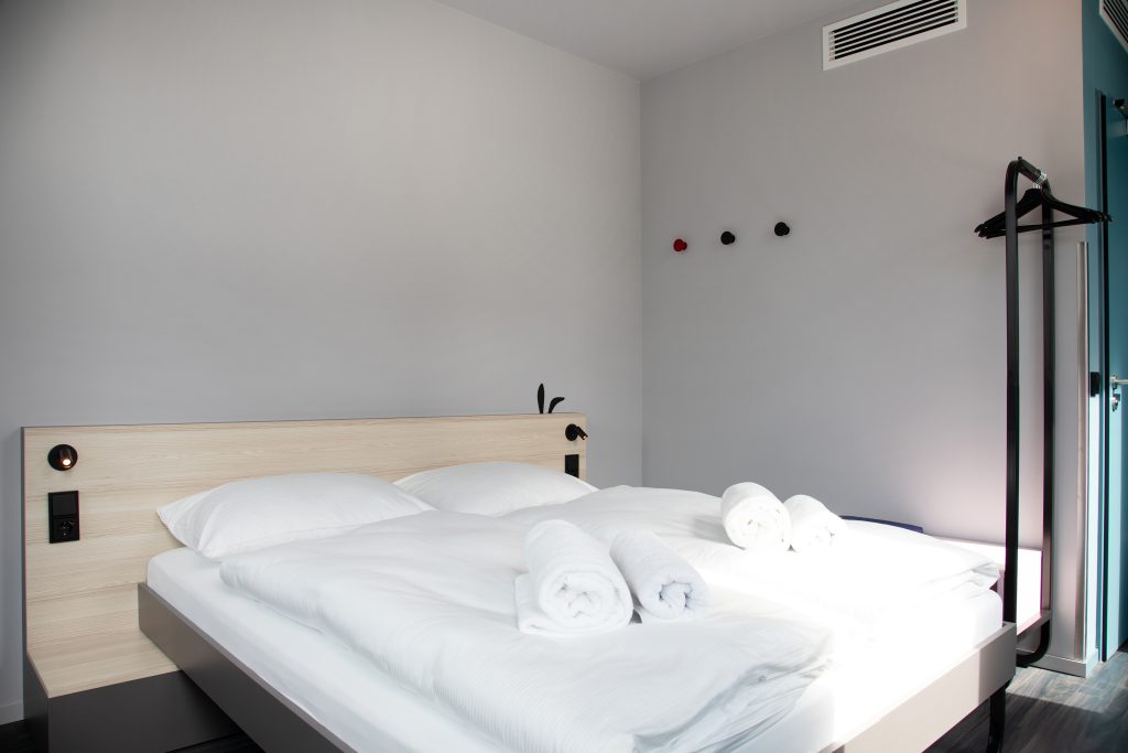 MEININGER Hotel Bremen Hauptbahnhof room with comfy double bed and fresh towels ready