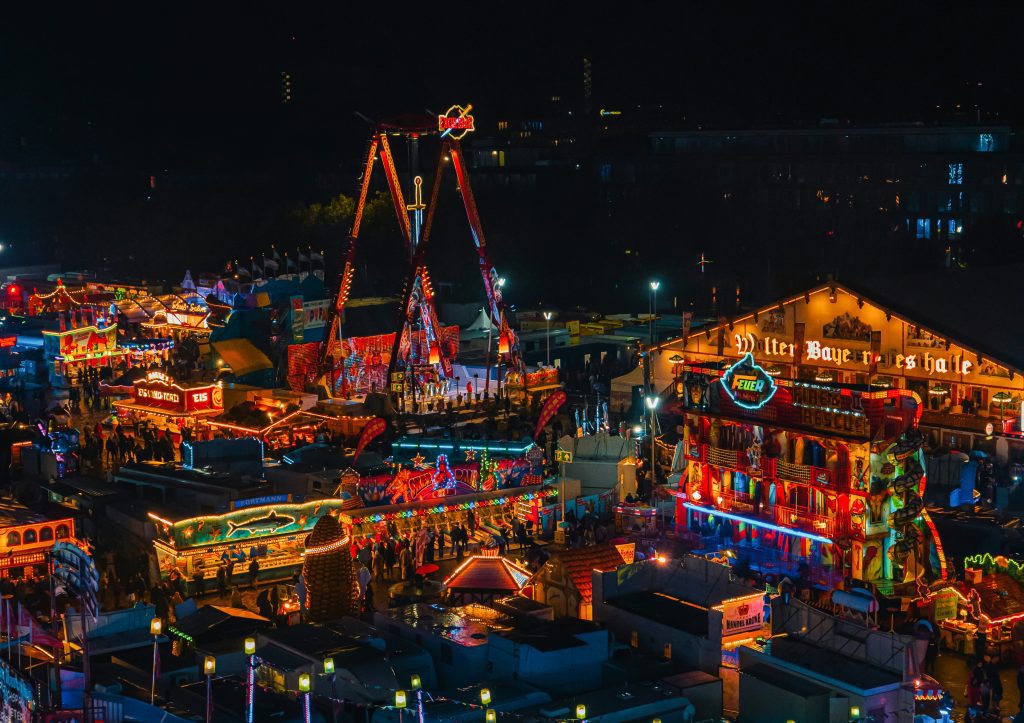 Freimarkt Bremen: Colorful rides and food stalls glowing at night