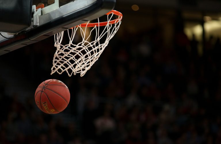 Close up of a basket ball entering the net
