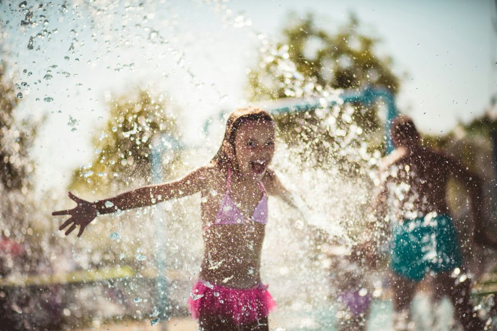 Things to do in Marseille with kids: kid having fun at a splash park in Marseille