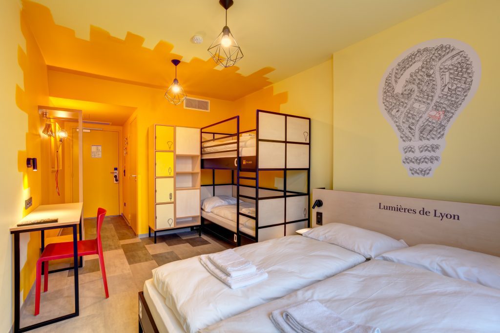 MEININGER Hotel Lyon Centre Berthelot: camera con pareti giallo brillante, due letti singoli e armadietti personali