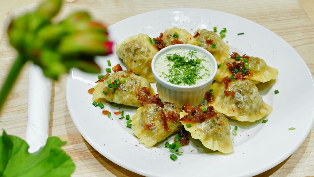 Eating in Krakow: Crispy pan-fried pierogi with caramelized onions and a dipping sauce