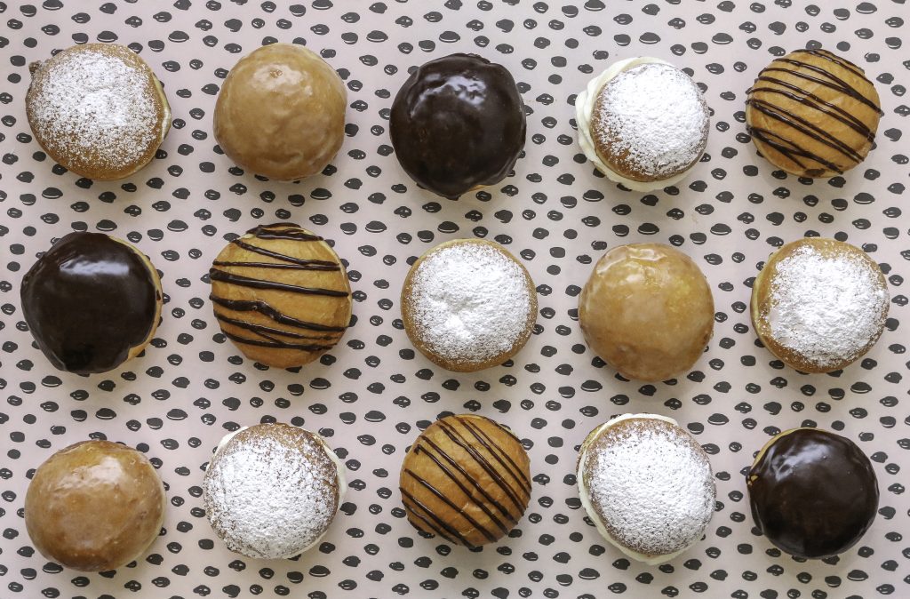 Eating in Krakow: Assorted Polish pączki with powdered sugar, chocolate and caramel glaze