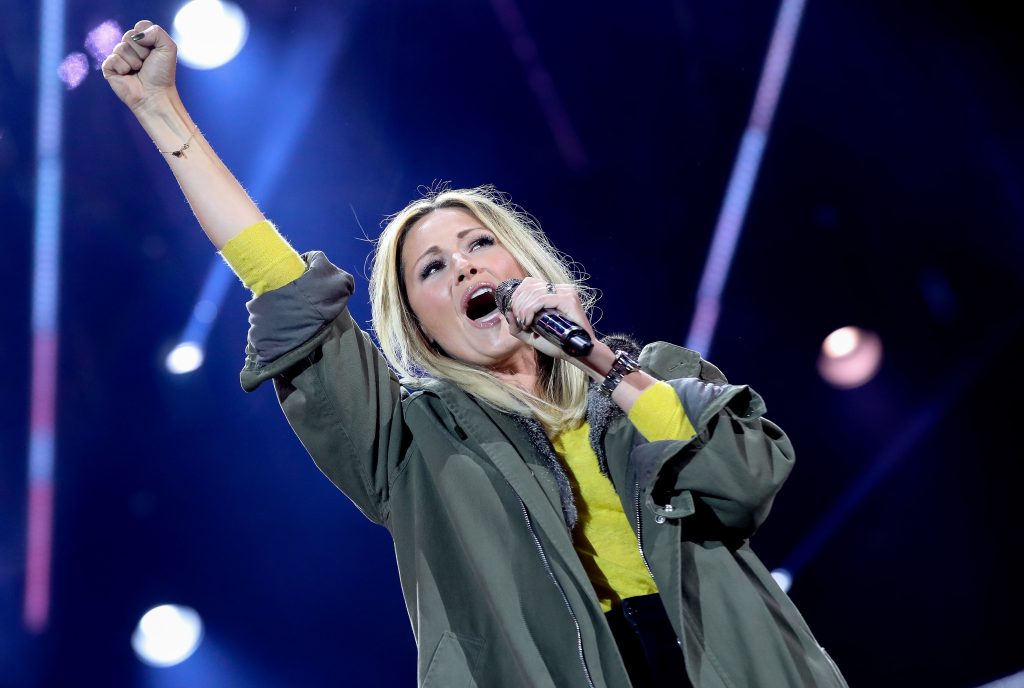 Helene Fischer tour 2026: Helene Fischer singing live on stage with microphone and raised fist