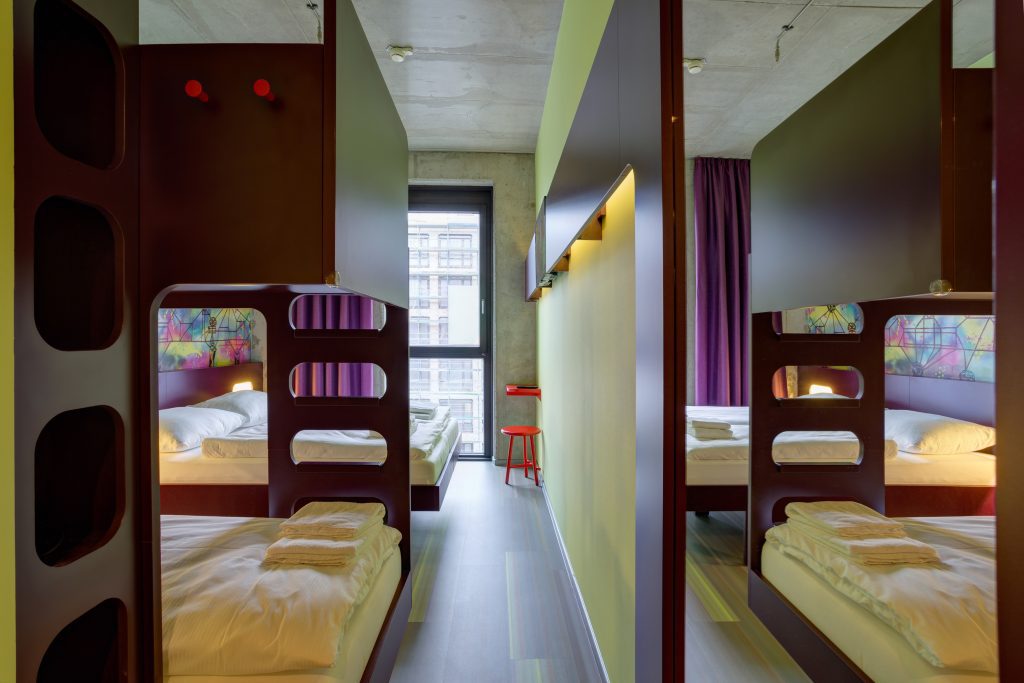 Shared dorm room with bunk beds in modern hostel
