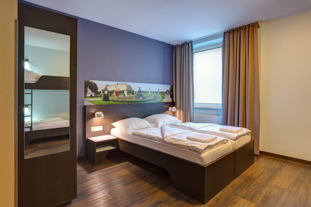 Bright double room with large window and wooden floor