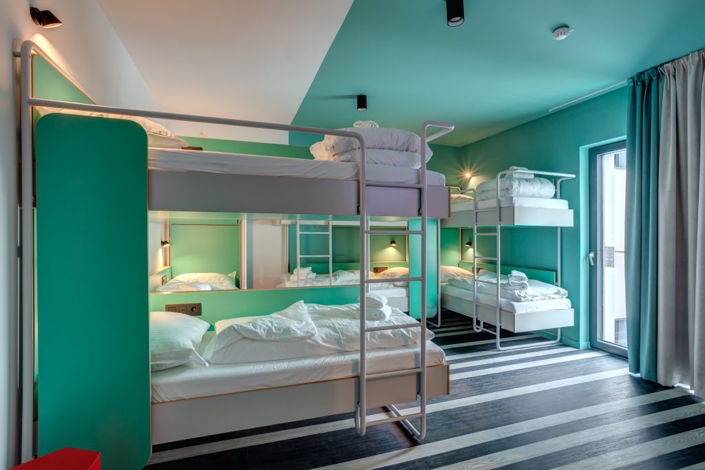 Helles Schlafsaal mit grünen Etagenbetten in Brüssel