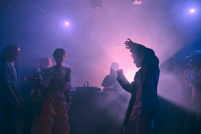 people dancing lightened by colorful lights