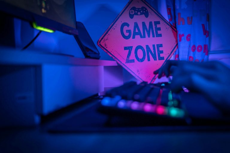 Game zone sign on a neon colored keyboard