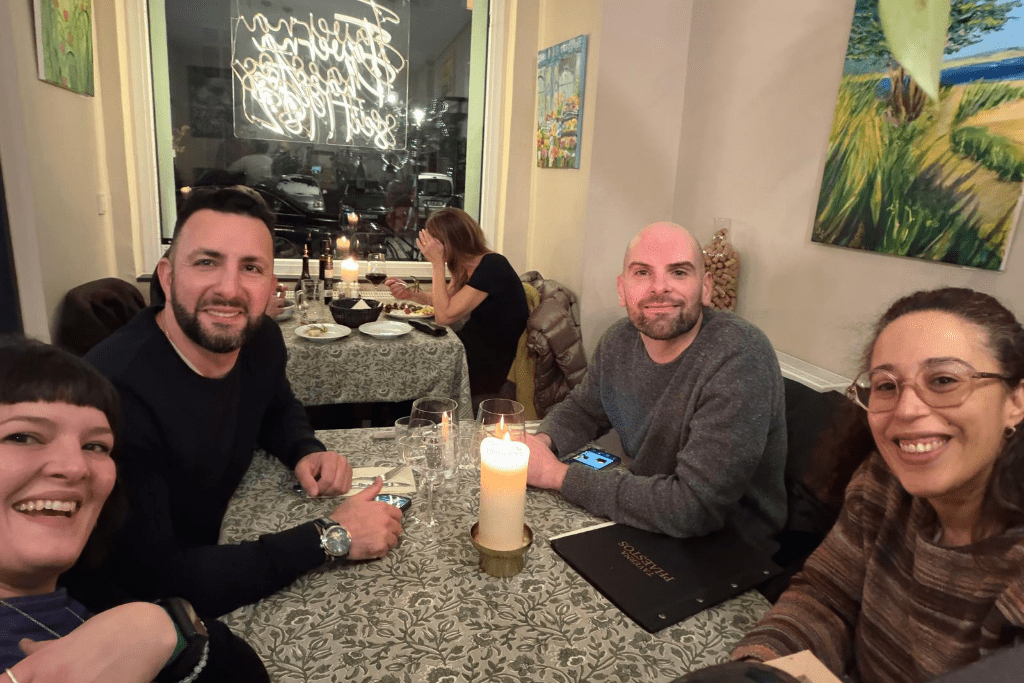 Will and his colleagues at a bar table enjoying a drink