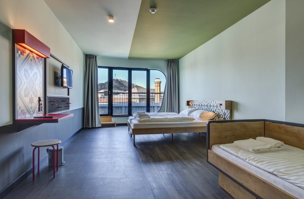Bright private room at MEININGER Budapest with view of Gellért Hill