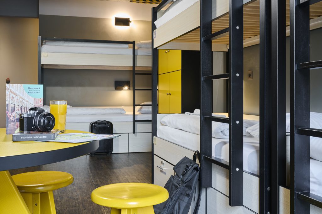Dorm room with bunk beds and yellow furniture