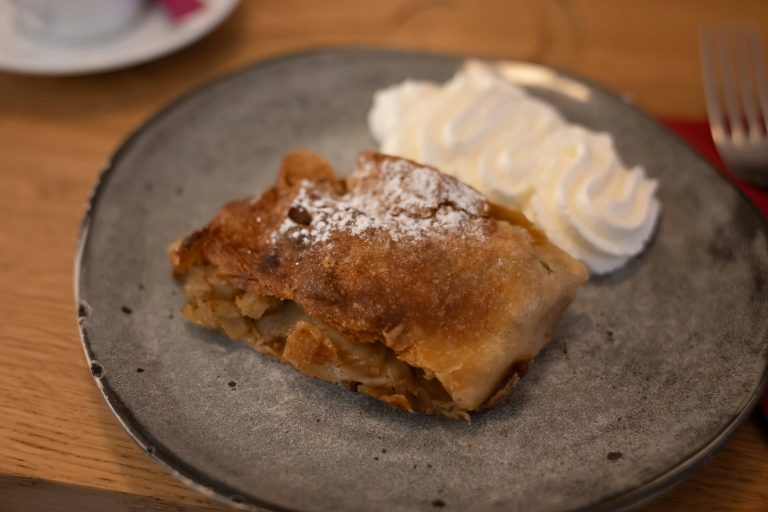 A plate with strudel and cream