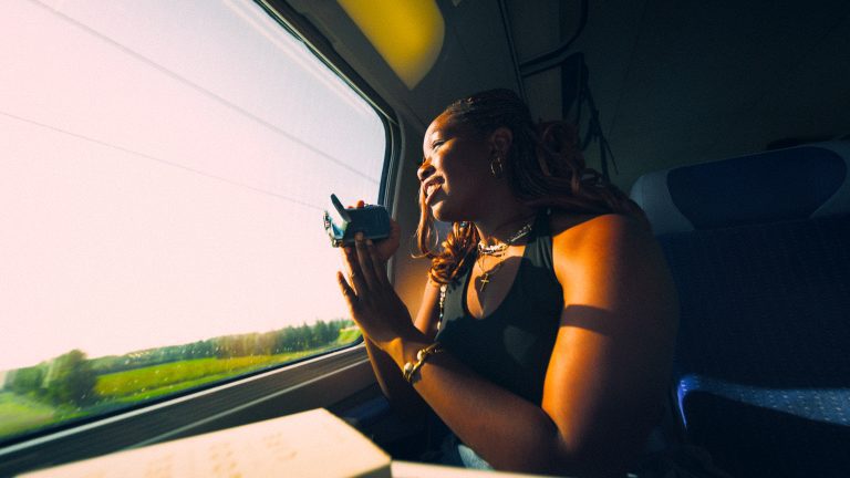 Female backpacker looking out of a train window