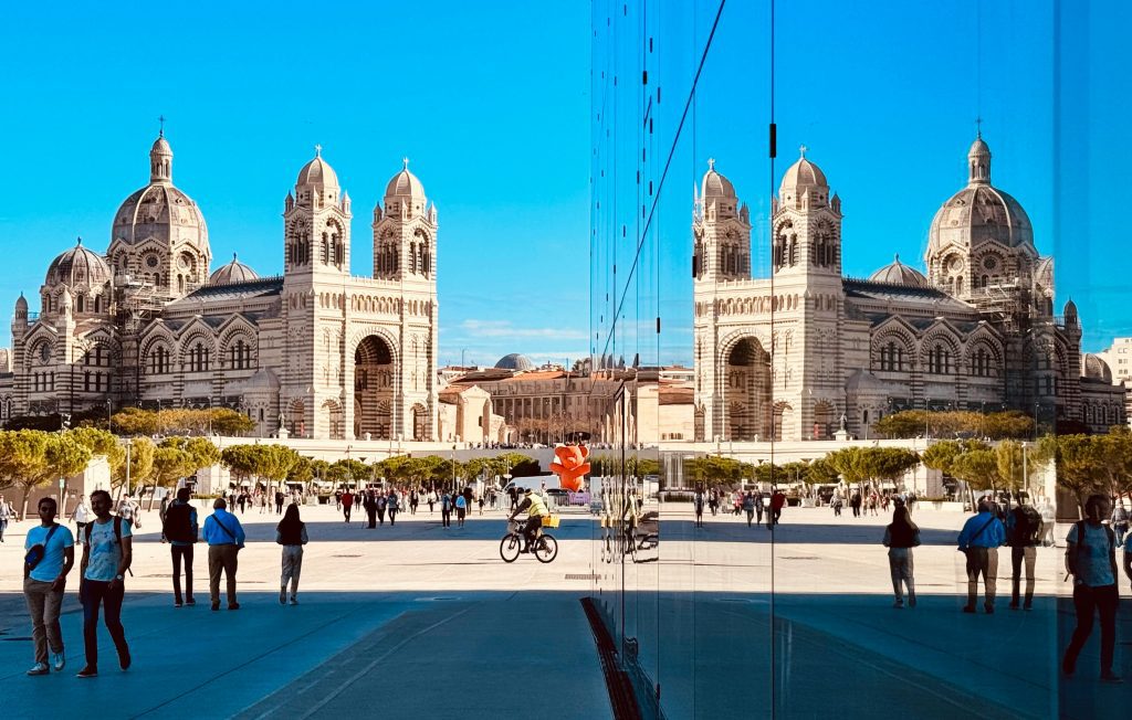 Backpacking France on a budget: Marseille cathedral reflected on the MuCEM glass wall