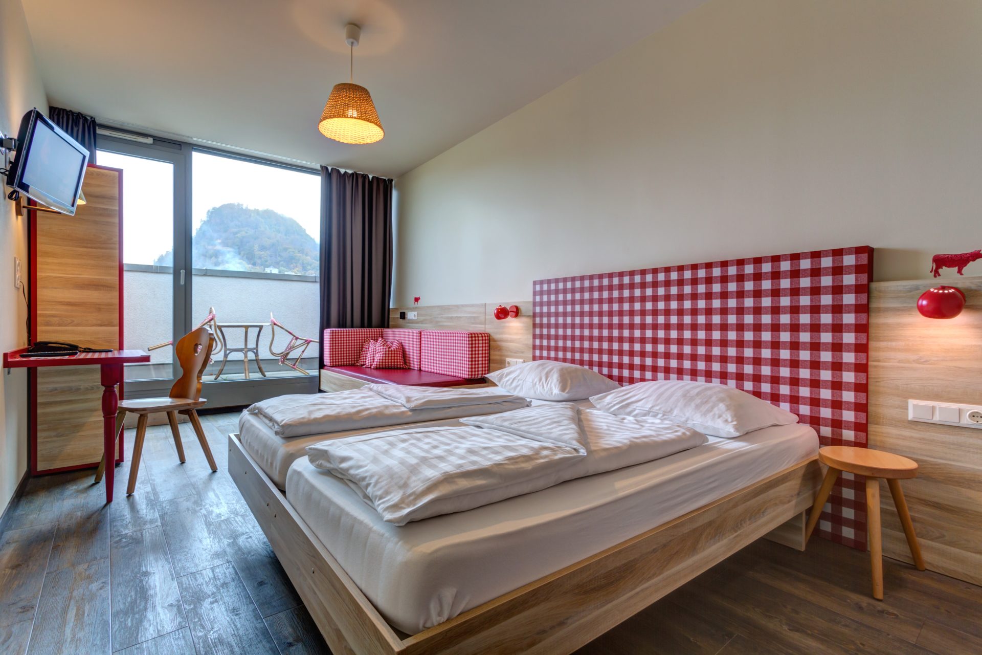 Spacious double room at MEININGER Hotel Salzburg City Center with balcony