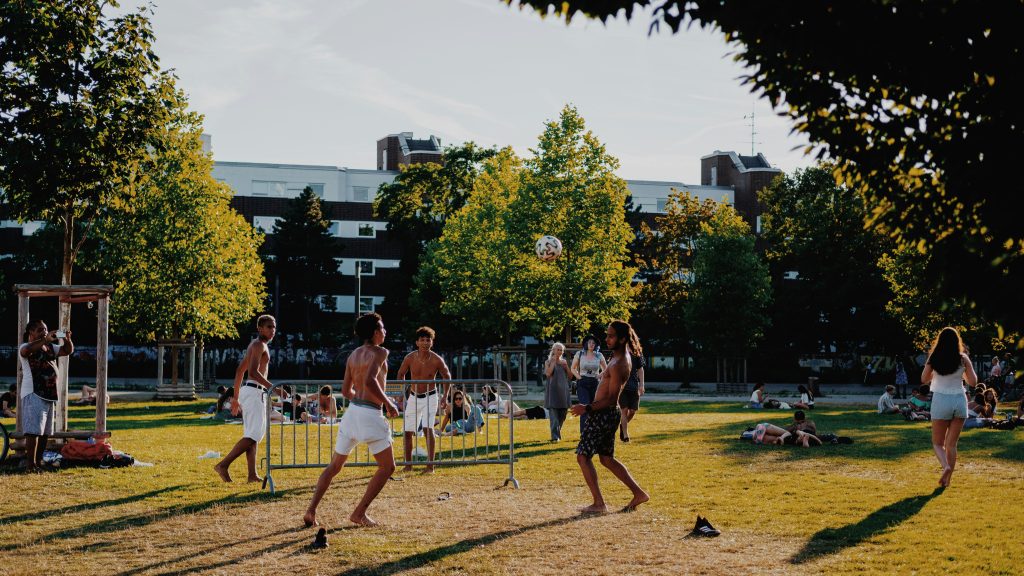 Young people playing football at the park