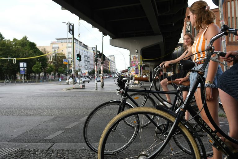 Girls on bikes at the traffic light in Berlin
