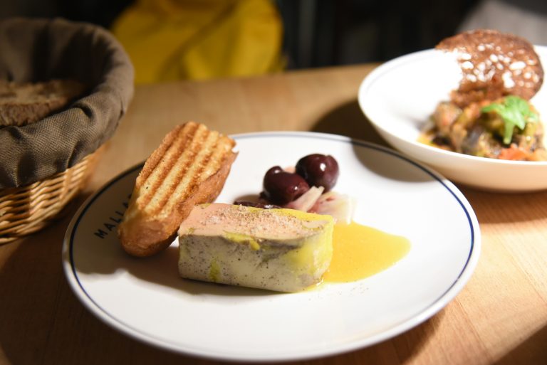 Foie gras with toast and olives on a plate