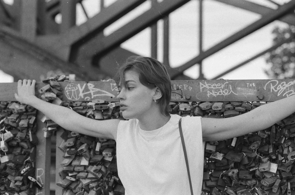 Cologne Instagram spots: Woman posing at the love lock wall on the Hohenzollernbrücke in Cologne