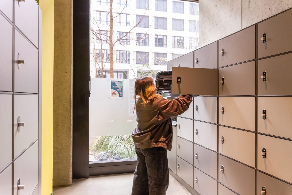 Girl picking up her luggage from a hotel luggage deposit