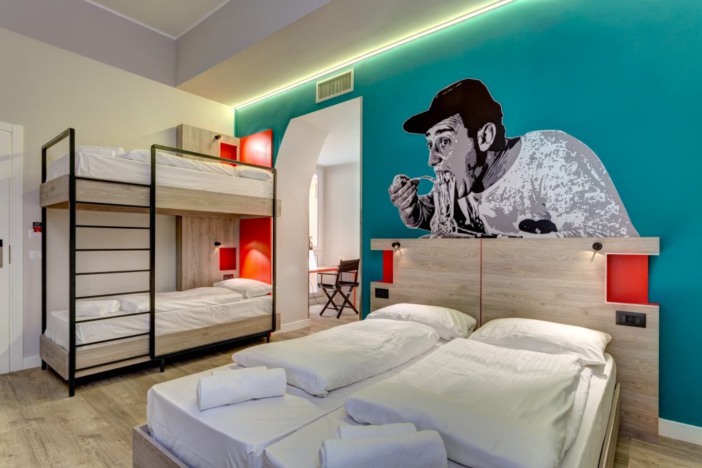 Family room with bunk beds and a teal wall mural of a man eating spaghetti
