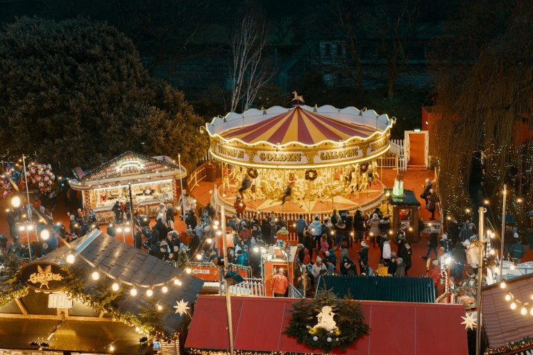 Aereal view of a Christmas market and a carousel at night