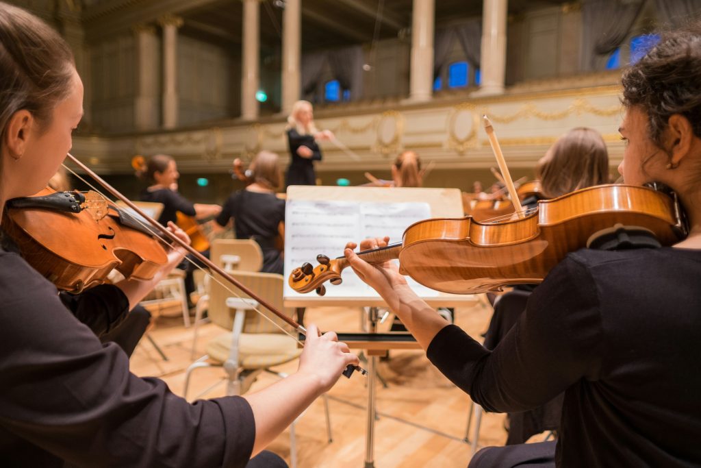 Violinists playing live in a grand concert hall during Mozart Week in Salzburg