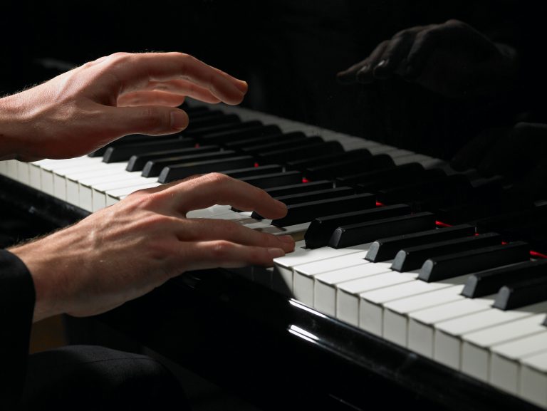 Hands playing the piano