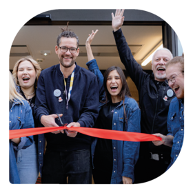 Employees cutting the ribbon at a new MEININGER Hotels opening