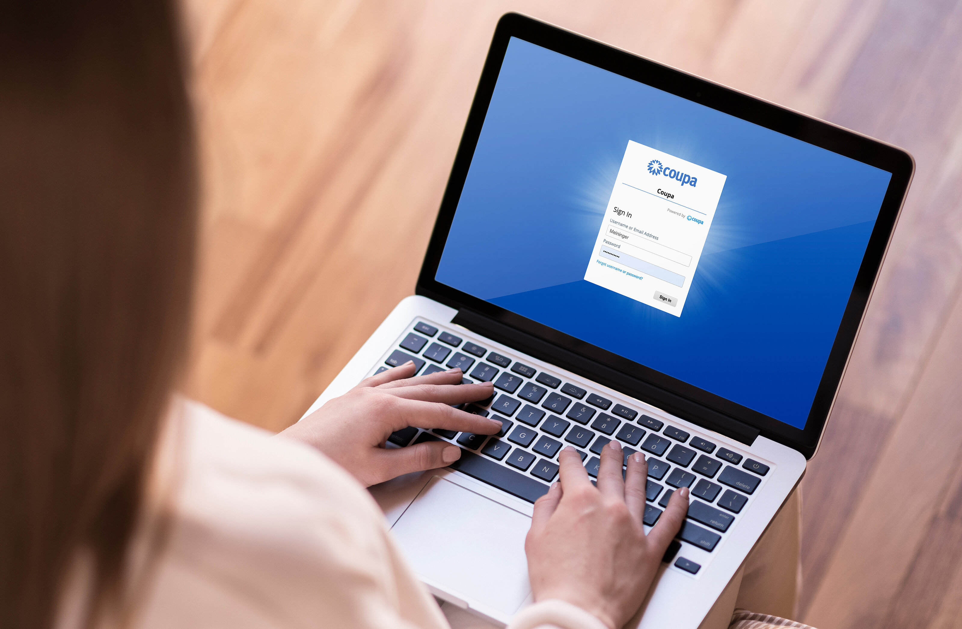 A workig woman on her laptop opening our new supplier: Coupa