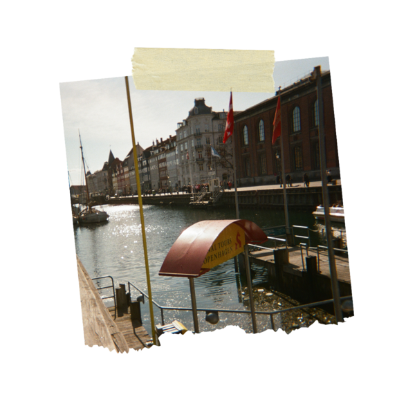 A building in Copenhagen facing a canal with a boat