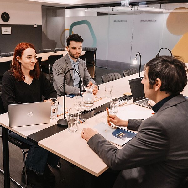 Three people having a meeting in a meeting room