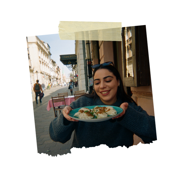 A girl showing her pierogi on a plate
