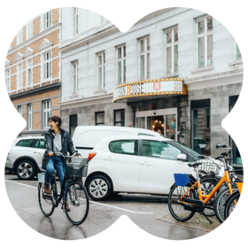 Guest cycling near MEININGER Hotel promoting sustainable mobility