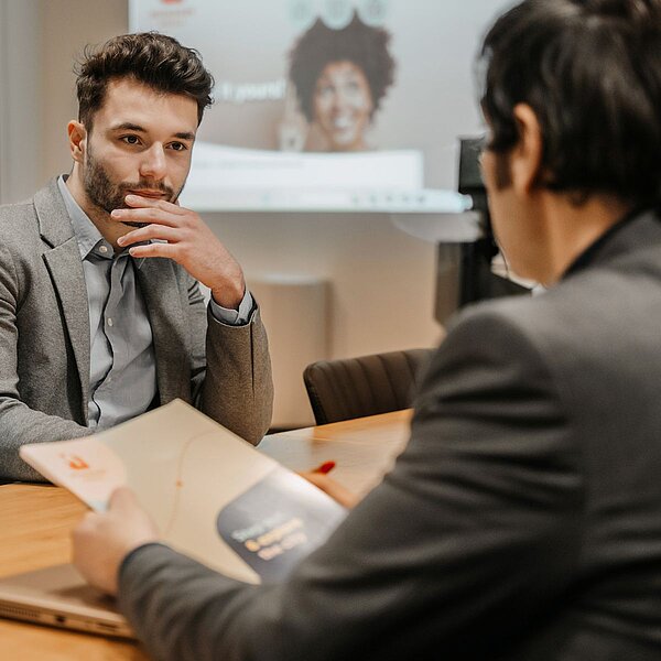 Two workers having a meeting at a table